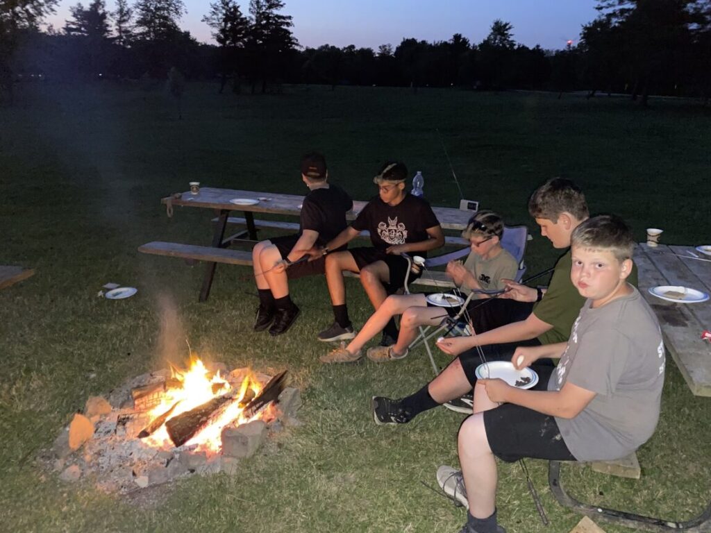 Students sitting around a campfire